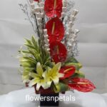 7 red Anthurium 3 white Oriental lily with dry stick + 1 Kg. Fresh Fruit cake